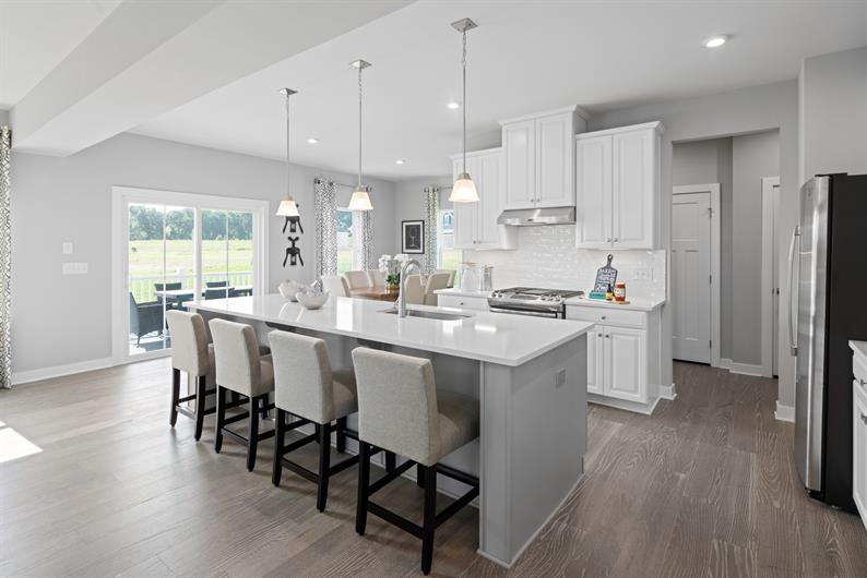 LUXURY FINISHES INCLUDE UPGRADED CABINETS & FLOORING, QUARTZ COUNTERS & STAINLESS STEEL APPLIANCES 