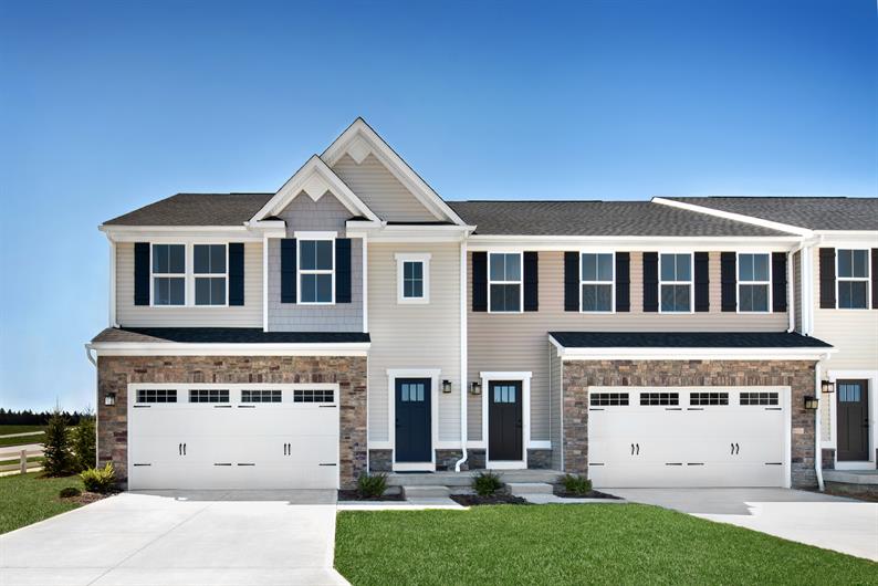 STONE DETAILS AND TWO-CAR GARAGES OFFER CURB APPEAL AND STORAGE 