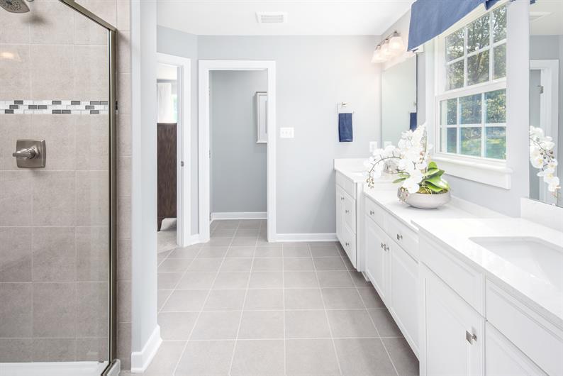 The ensuite bathroom includes a walk in closet and upgraded finishes 