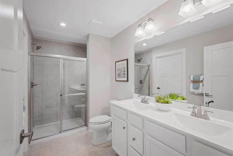 AN EN SUITE WITH SEATED SHOWER AND PLENTY OF CLOSET STORAGE 