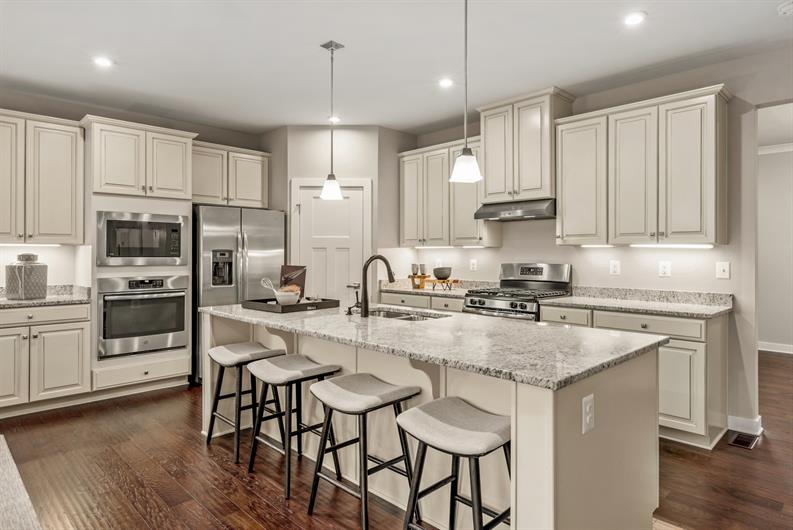 LUXURY FINISHES INCLUDE UPGRADED CABINETS, FLOORING, QUARTZ, & STAINLESS STEEL APPLIANCES 